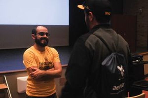 T.J. Jourian speaks to a student after his keynote