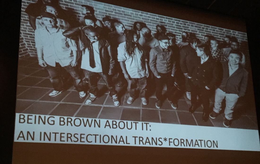A powerpoint slide with a group picture of 22 brown bois standing together. Underneath the picture is the title 