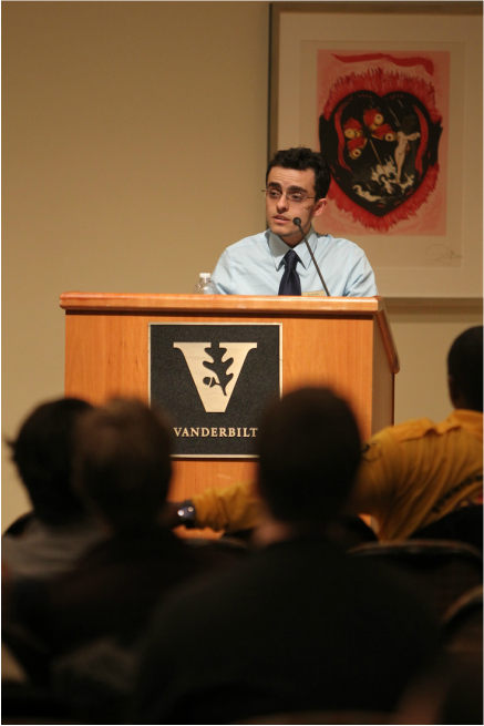 Speaking from behind podium at Vanderbilt University