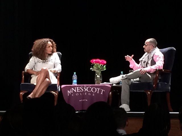 Picture of Janet Mock and T.J. Jourian on stage sitting somewhat across from each other in conversation.